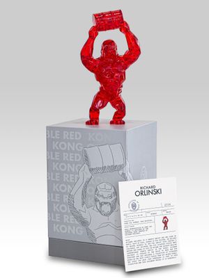 a close up of a statue of a man holding a red object