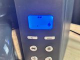 a coffee maker with a digital clock on it