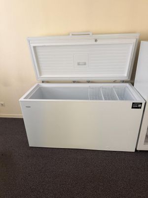 a white chest freezer sitting in the corner of a room