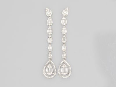 a pair of diamond and white gold earrings