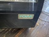 a black oven with a polar logo on it