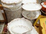 many plates and bowls sitting on a table in a room