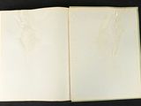 an open book with a drawing of a bird on it