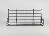 a black wire rack with a bunch of books on it