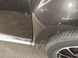 a close up of a car door with the door open