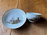 a small cup and saucer sitting on a wooden table