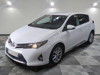 the white toyota corollant is parked in the garage