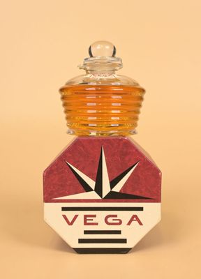 a small glass bottle with a red and white label on it