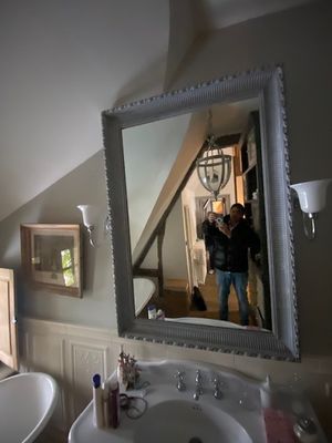 a man taking a picture of himself in the mirror in the bathroom
