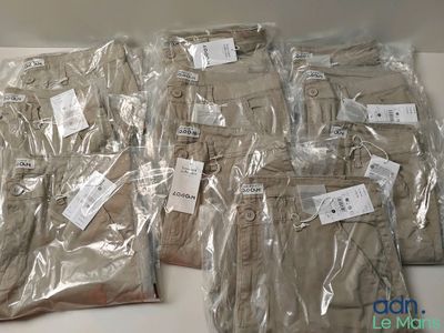many bags of clothing sitting on a table