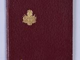 an old passport with a gold emblem on it sitting on a white surface
