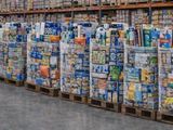 a large amount of soda cans stacked on pallets in a warehouse
