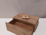 a small wooden box with a lid open on a white surface
