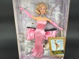 the barbie doll is in a pink dress and pink gloves