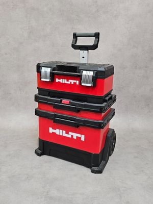 two red tool boxes sitting on top of each other on a gray surface