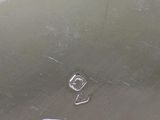 a close up of a piece of metal with a button on it