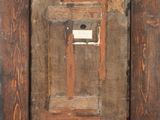 an old wooden picture frame with a picture of a door in it