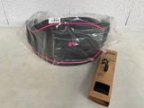 a black bag and a pink belt on a table