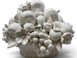 a white vase with a bunch of white flowers in it
