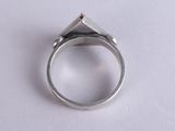 sterling silver ring with a red stone in the middle on a white surface