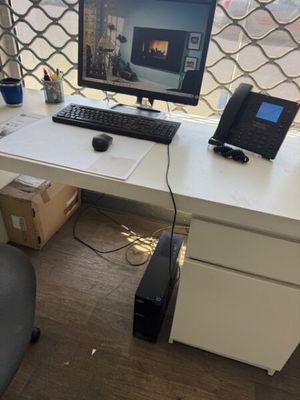 a desk with a computer and a phone on it