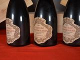 three bottles of wine sitting on a table next to each other
