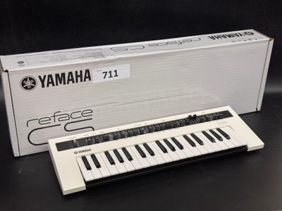 an image of a white electronic keyboard sitting on top of a table