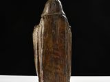 an old wooden statue of a bird on a white surface