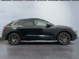 the audi q4 is parked in a showroom with a white wall