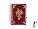 an old red book with a gold cross on top of it