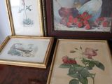 two framed pictures of flowers and a vase on a table