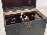 une petite boîte noire ouverte posée sur une table
