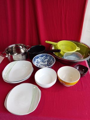 a red table with many dishes and bowls on it