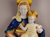 an image of a figurine of a woman holding a child