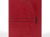 un cahier rouge avec une couverture rouge et un stylo noir