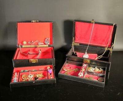 two boxes that have jewelry inside of them on a table