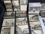 a lot of old black and white pictures on the table