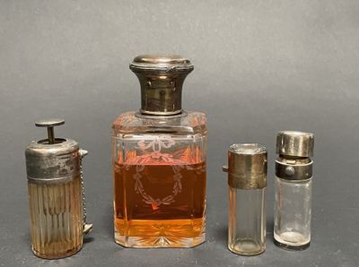 a small bottle of perfume next to a smaller bottle of salt and pepper shakers