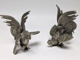 pair of antique silver plated parrot figurines on white background