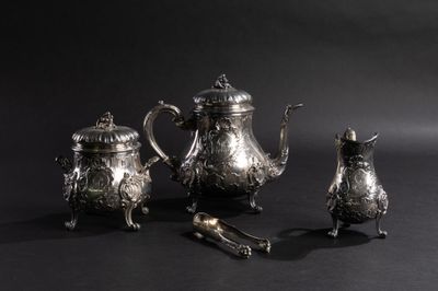 un service à thé et à café en argent, composé de trois pièces, sur fond noir