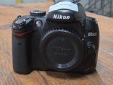 a camera sitting on a wooden table with a blurry background