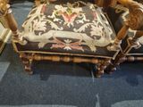 a chair that has a cushion on it in a room