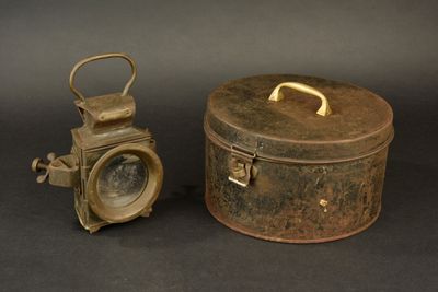 a small metal box with a metal handle and a small metal box with a metal handle
