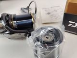 a box of fishing reels and a reel on a table