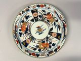 a plate with a design of flowers and birds on it