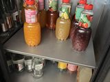 many bottles of juices and drinks in the fridge