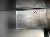 a sign on the side of a stainless steel refrigerator