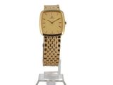 an image of a gold watch on a stand on a white background