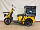 a yellow scooter with a tv on the back
