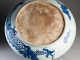 a blue and white bowl with a dragon design on it